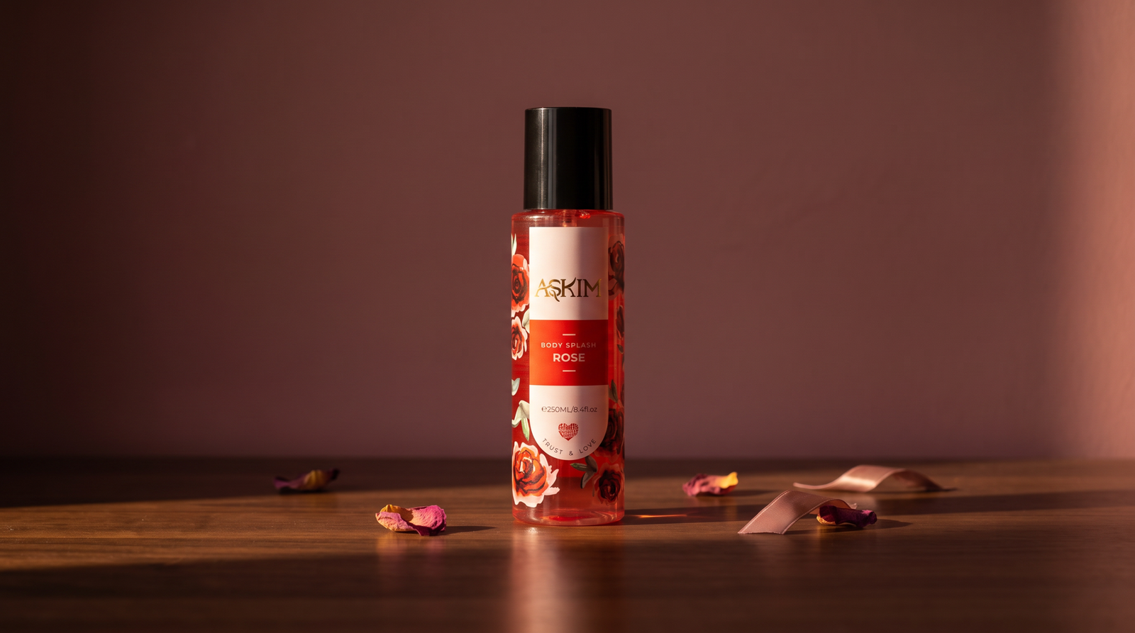 Body splash vs body mist: Askim Rose Body Splash bottle centered on a walnut wood surface