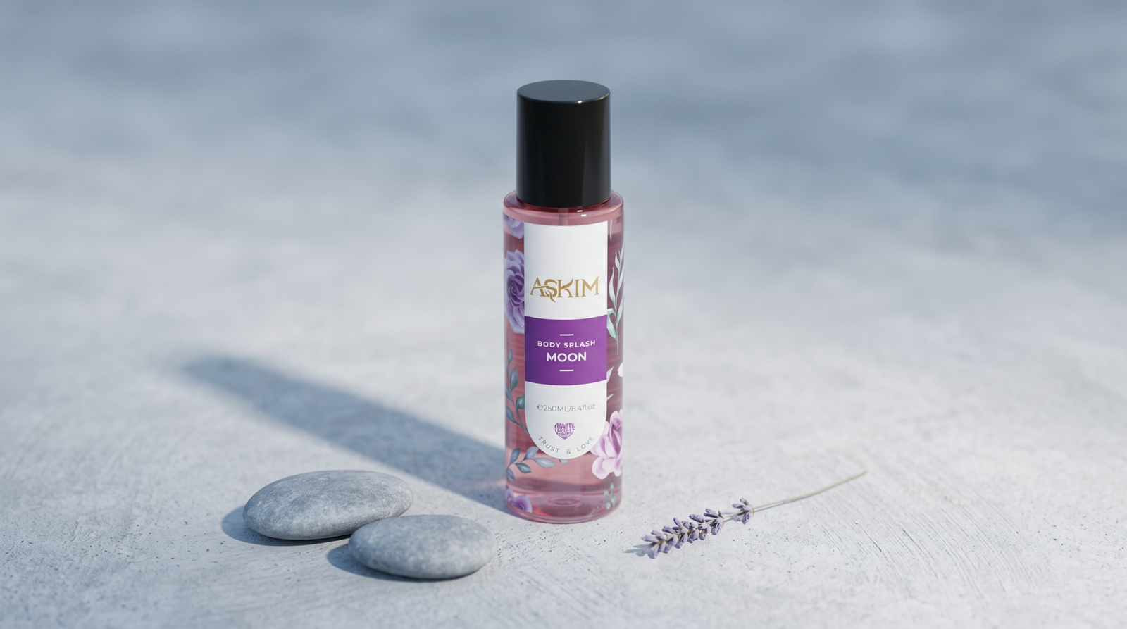 Long-lasting body splash: Askim Moon Body Splash bottle centered on a pale concrete surface