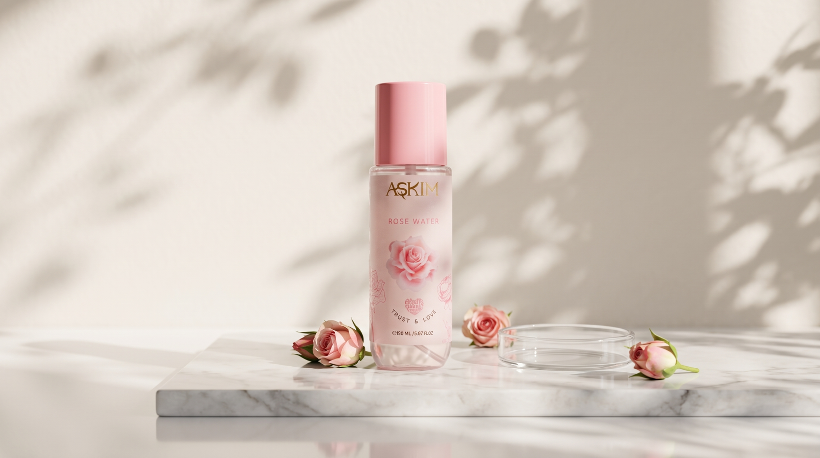 Rose water for skin: Askim rose water bottle centered on a marble slab in natural light