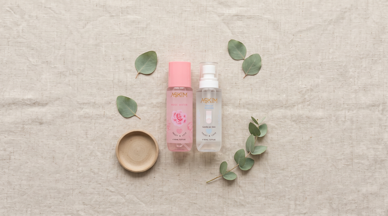 Safe skincare products: Askim rose water and makeup remover arranged on natural linen